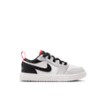 Kids low-top sneakers in white with black overlays and red lace accents