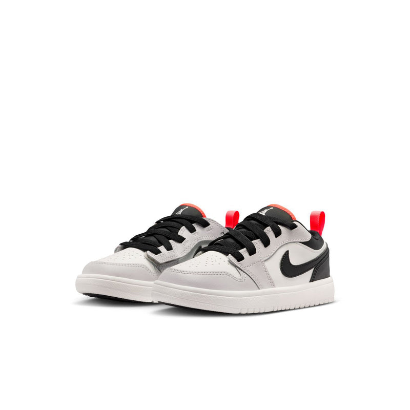 Kids low-top sneakers, white leather with black swoosh and red heel accents