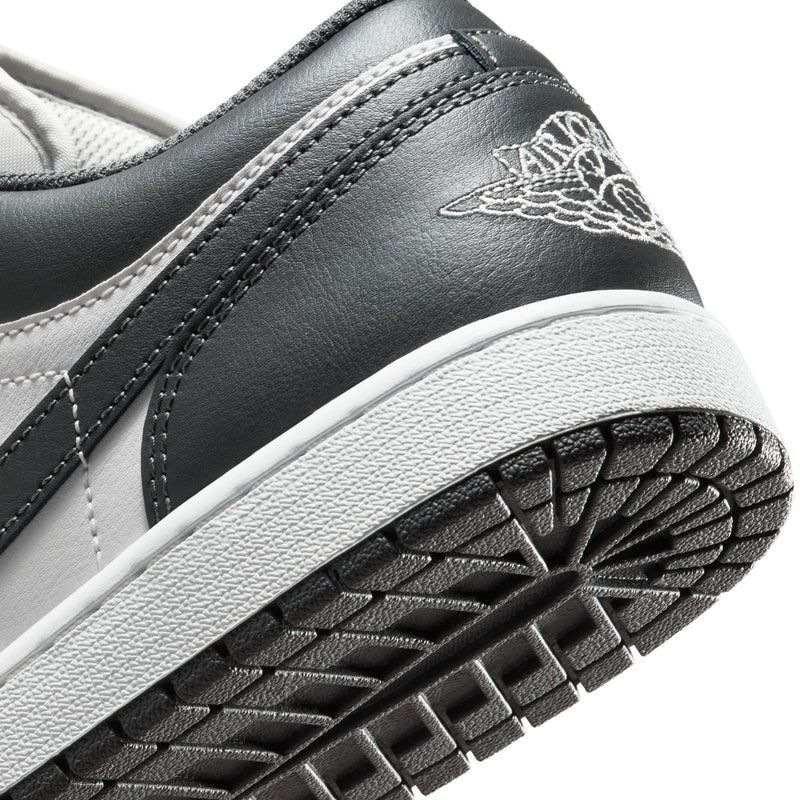 Close-up of dark gray low-top sneaker outsole and sidewall stitching