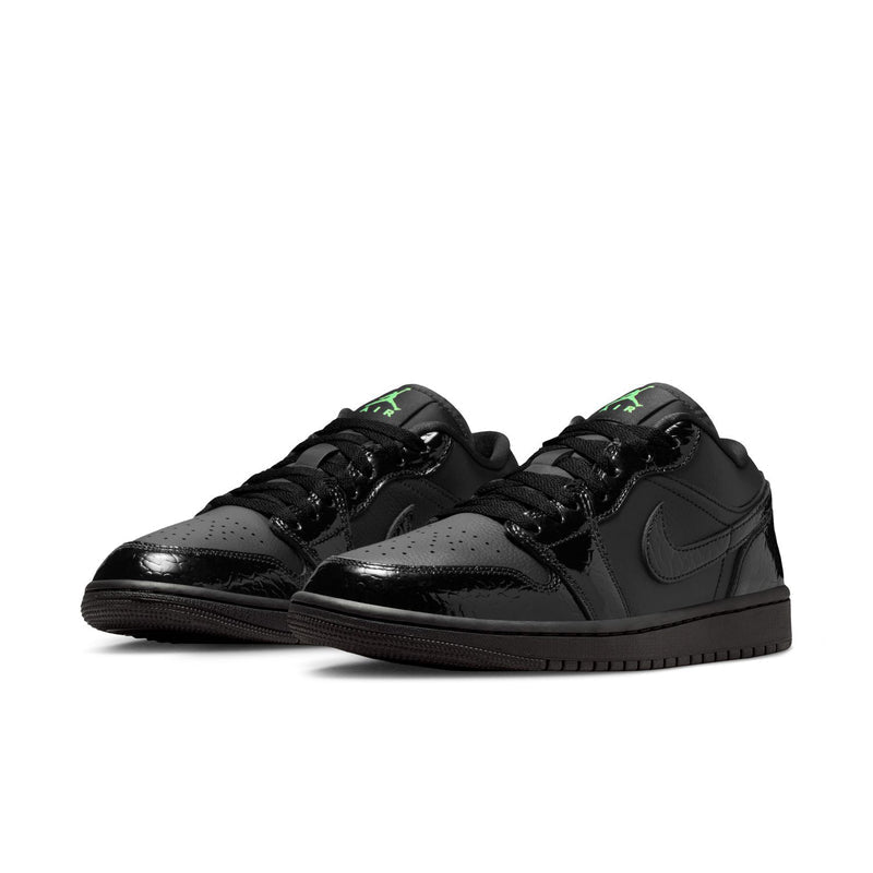 Pair of black low-top sneakers with green Jumpman accents on side panels.