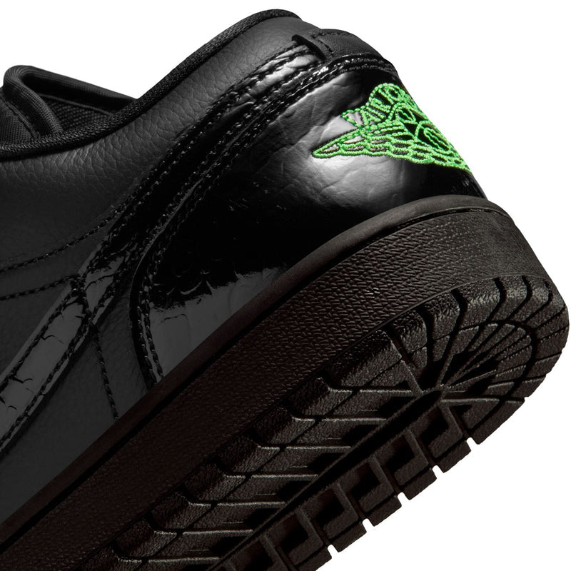 Black sneaker side panel with green Jumpman graphic and textured rubber outsole.