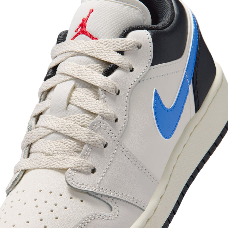 Youth low-top sneaker close-up, white laces, blue Swoosh, Jordan logo on tongue