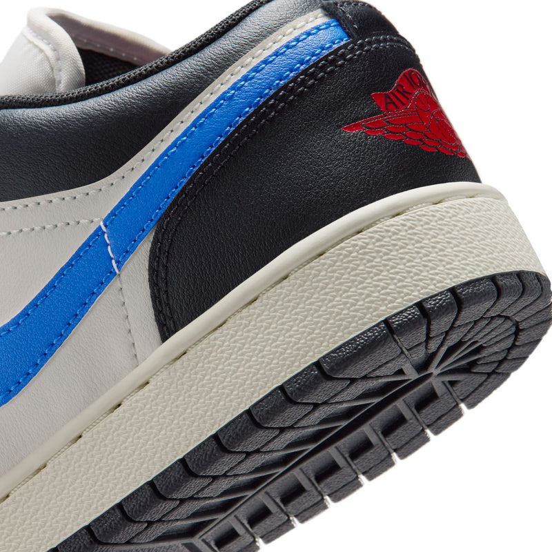 Youth low-top sneaker close-up, black outsole tread and red Jordan wing on heel