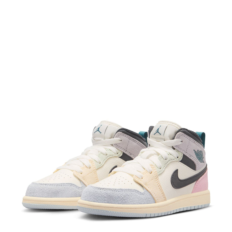 Kids AJ 1 Mid sneakers pair, white and pastel panels with black swoosh and teal wing heel logo