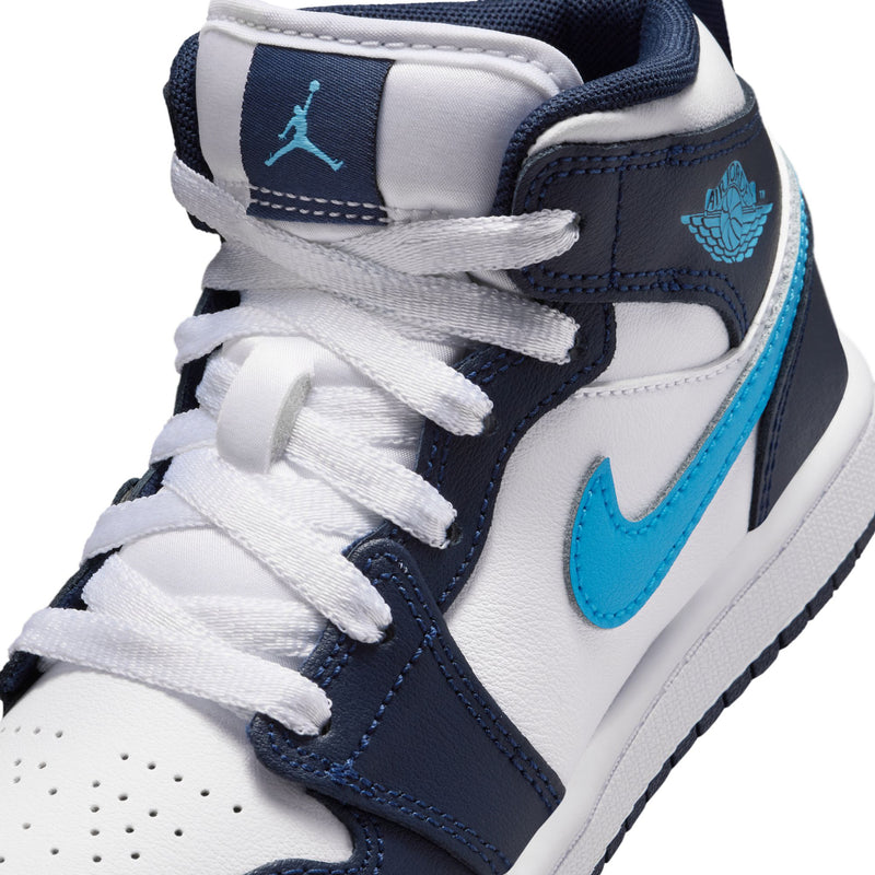 Close-up of kids' lace-up upper with navy overlays and light-blue sneaker details