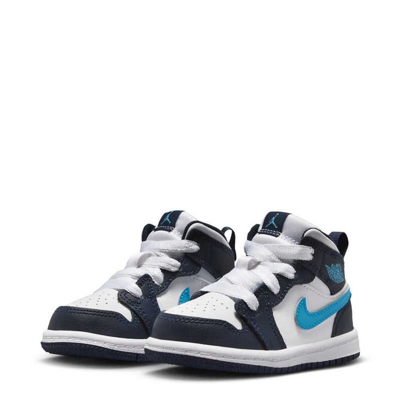 Toddler mid-top sneakers, side view with white uppers, navy overlays, light blue accents