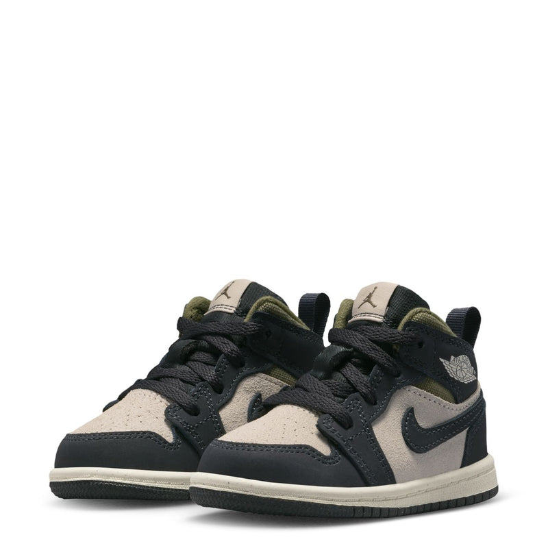 Pair of toddler mid-top sneakers, black and off-white uppers with olive ankle lining
