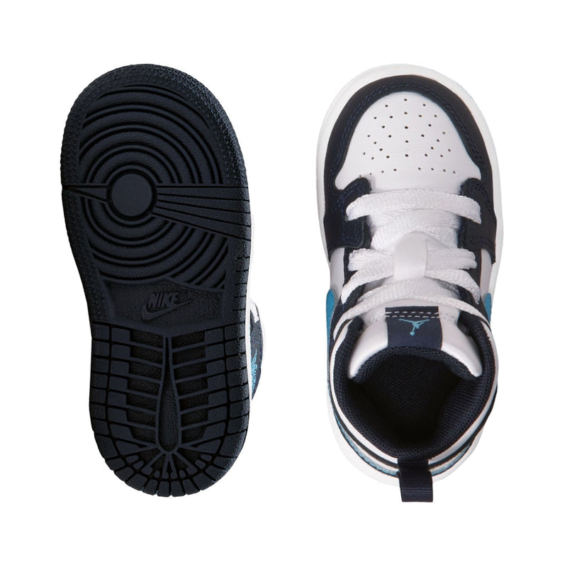 Toddler sneaker outsole and toe view, dark tread with white upper and navy interior