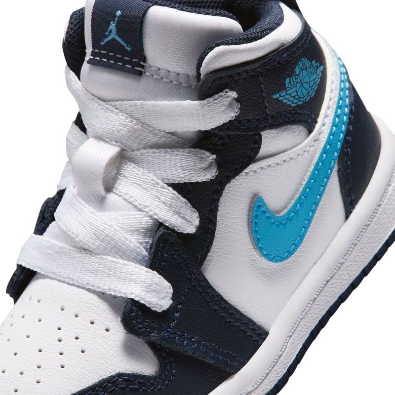Toddler sneaker close-up, white leather and navy with light blue swoosh and Jordan Wings