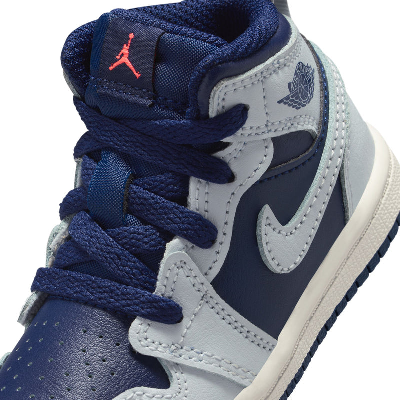 Toddler sneaker close-up with blue laces, Air Jordan tongue logo, stitched side panels