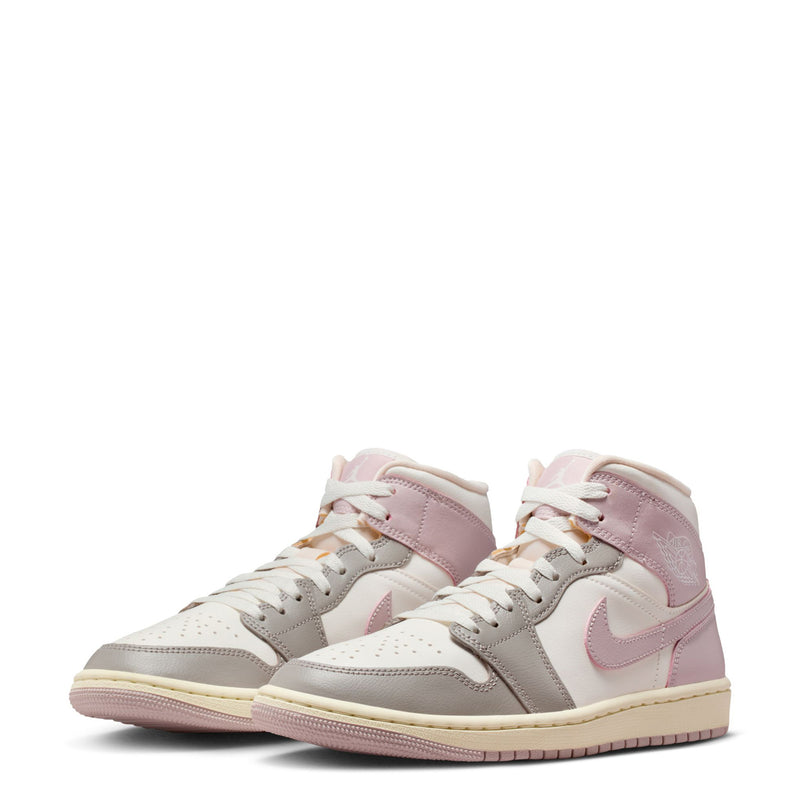 Pair of women's AJ 1 Mid sneakers in sail with pale pink overlays and gray panels
