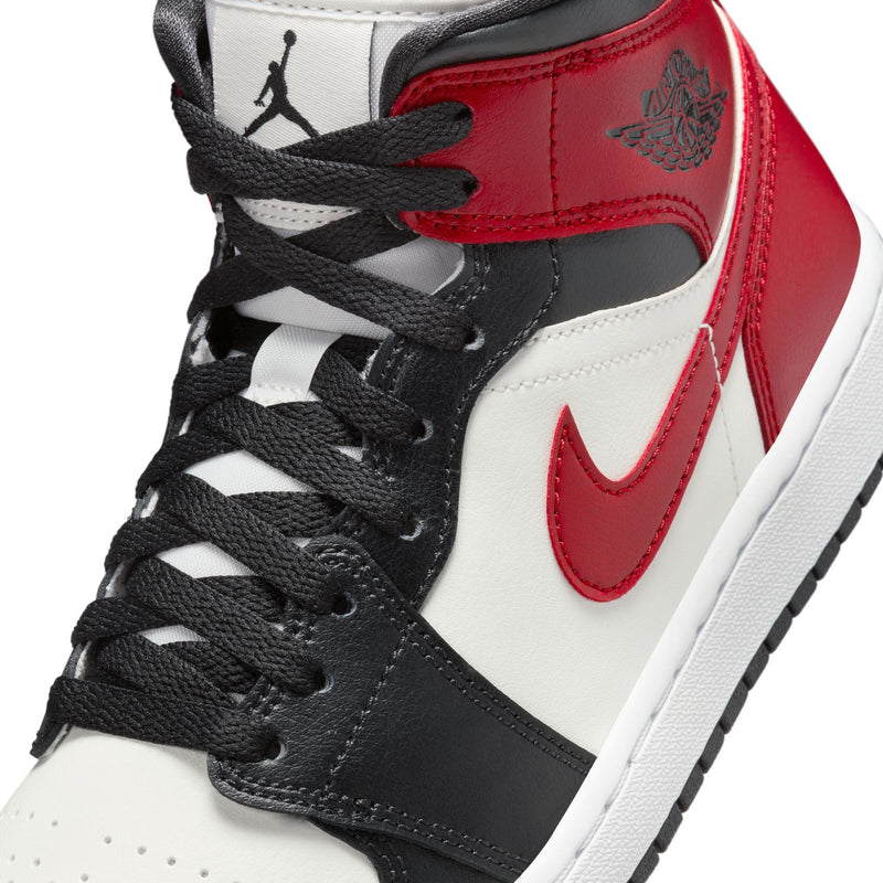 Women's Air Jordan 1 Mid sneakers, close-up of laces, red swoosh and black leather