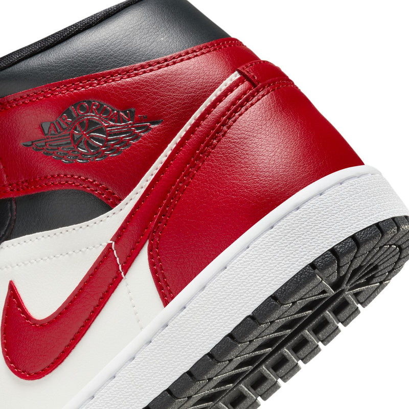Women's Air Jordan 1 Mid sneakers, close-up of Air Jordan logo on red upper