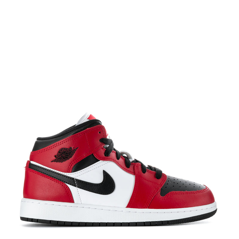Youth red, white and black mid-top sneakers with Nike swoosh and lace-up design