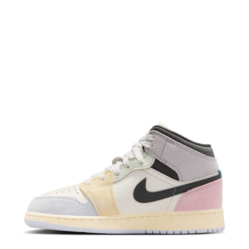 Air Jordan 1 Mid youth sneaker side view in white with black Swoosh and pink panel