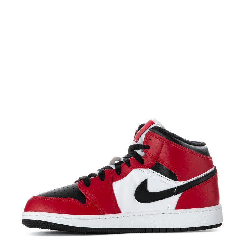 Youth red and black mid-top sneakers with white panels, Nike swoosh, and lace-up