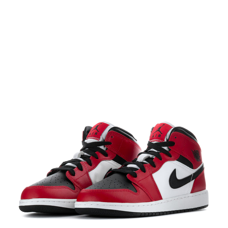 Pair of youth mid-top sneakers in red, white, and black with Nike swoosh details