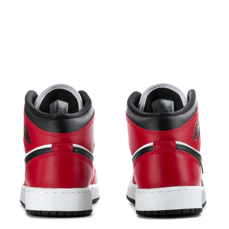 Youth mid-top sneakers heel view in red with white stripe and black collar