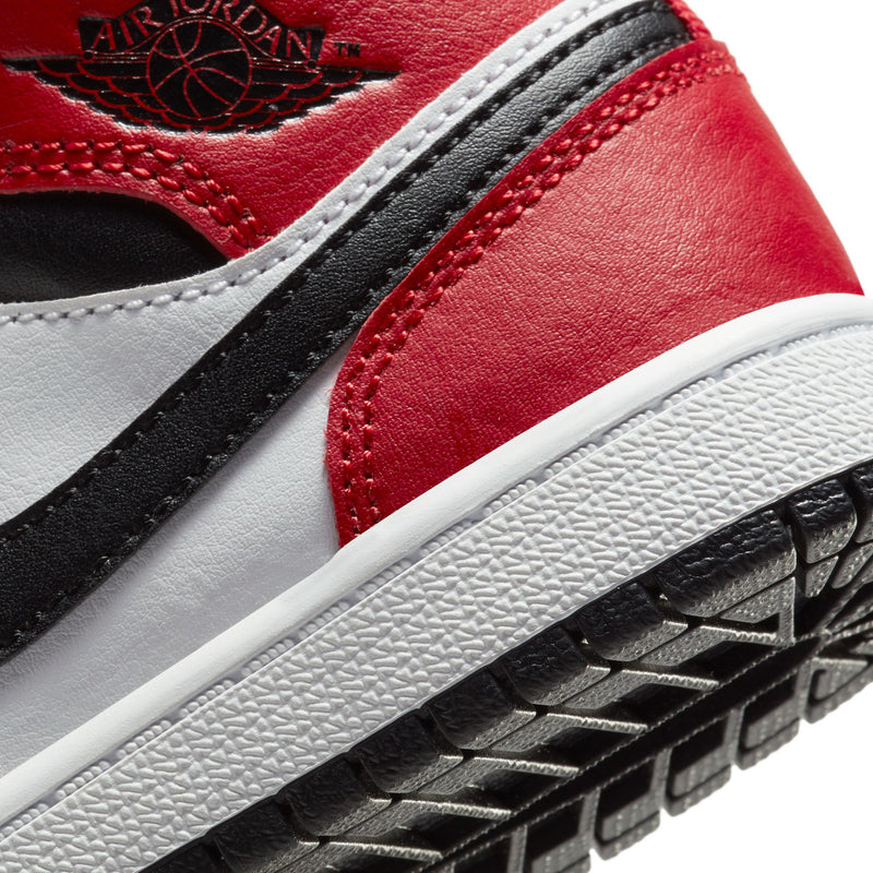 Kids Air Jordan 1 Mid close-up, wing logo and red leather with black outsole
