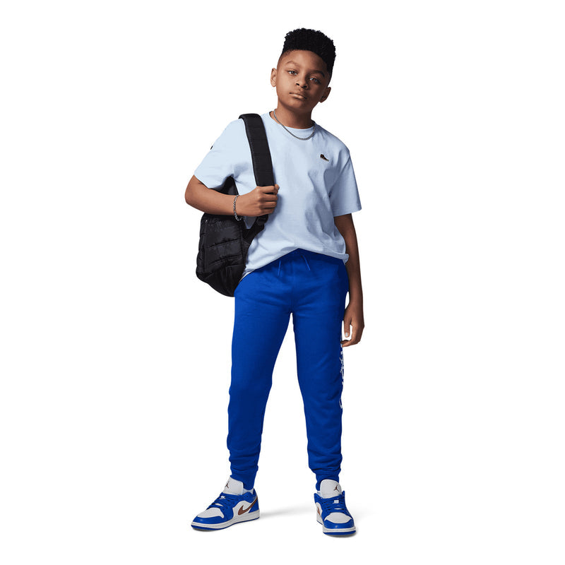 Youth light blue T-shirt with Jordan sneaker patch at left chest, worn front view