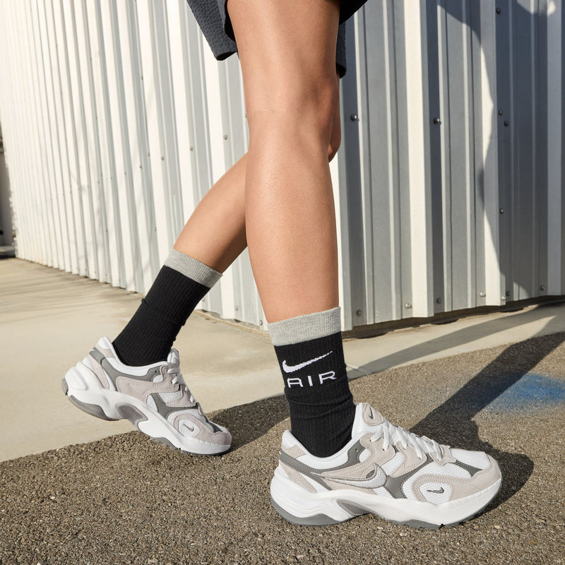 Chunky white and gray lace-up sneakers with thick sole and sporty side panels