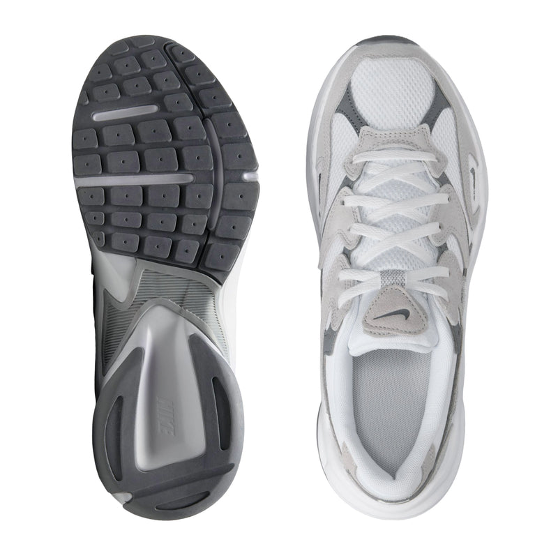 White lace-up sneaker showing outsole and side view with textured traction tread