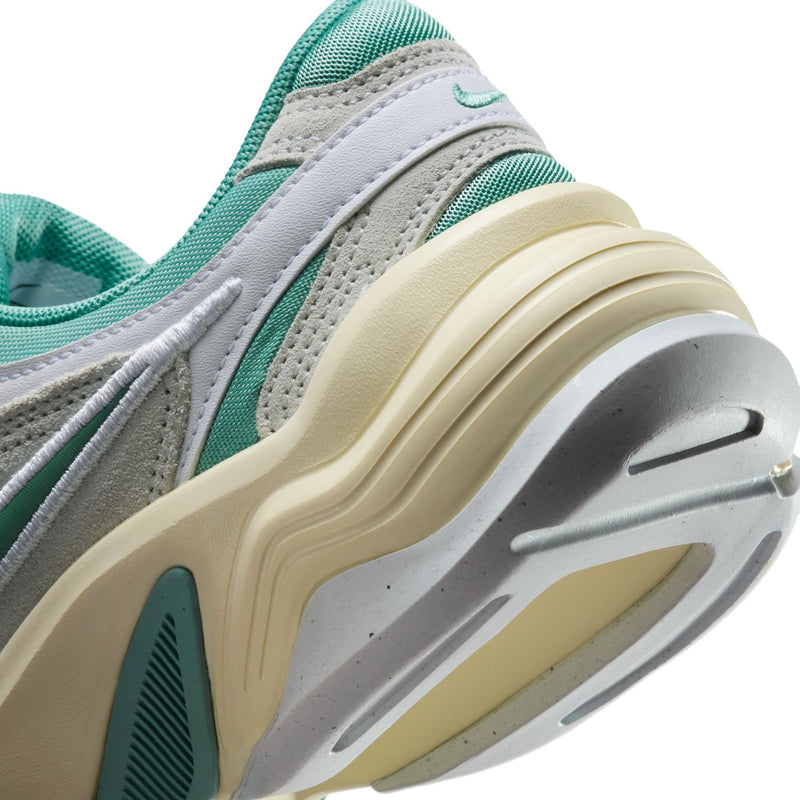 Women's sneakers close-up of midsole and heel, off-white with teal accents