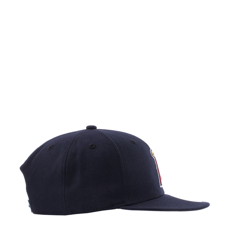 Navy baseball cap, side view with small embroidered emblem