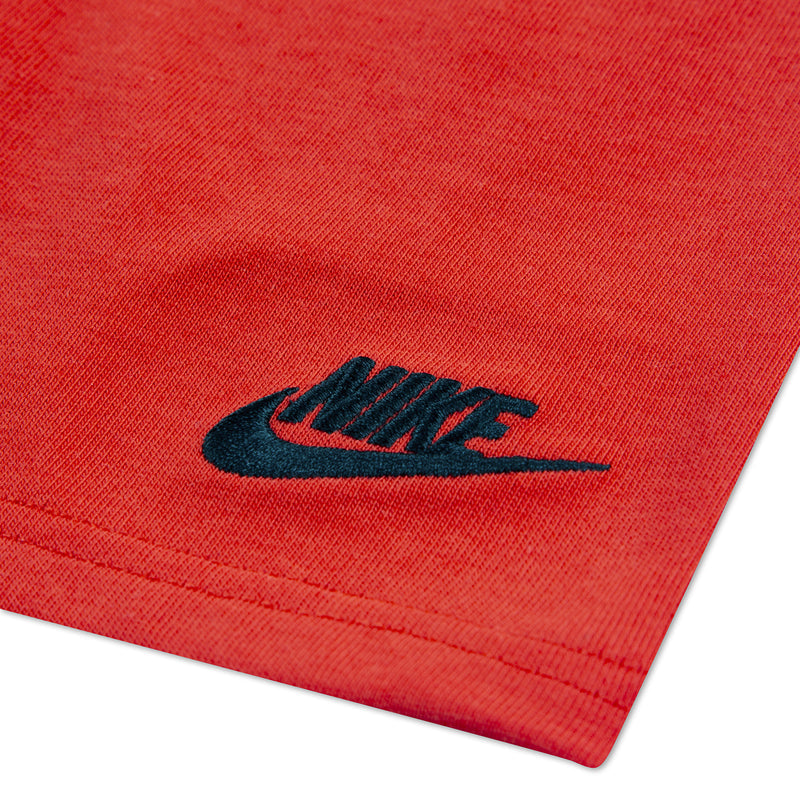 Red jersey shorts with navy Nike logo patch