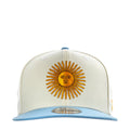 Cream baseball cap with embroidered sun face and light blue brim