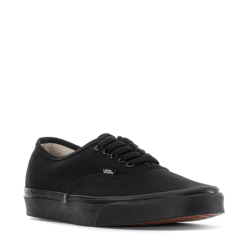 Black low-top canvas sneaker with lace-up front and Vans patch on tongue