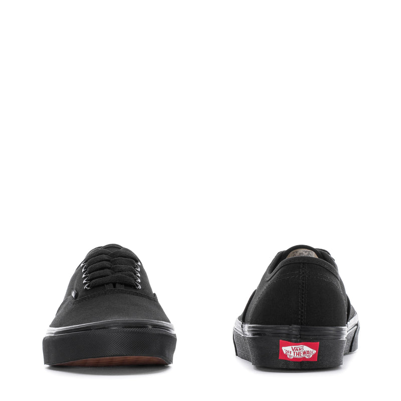 Black low-top canvas sneaker, heel and toe view with rubber cupsole