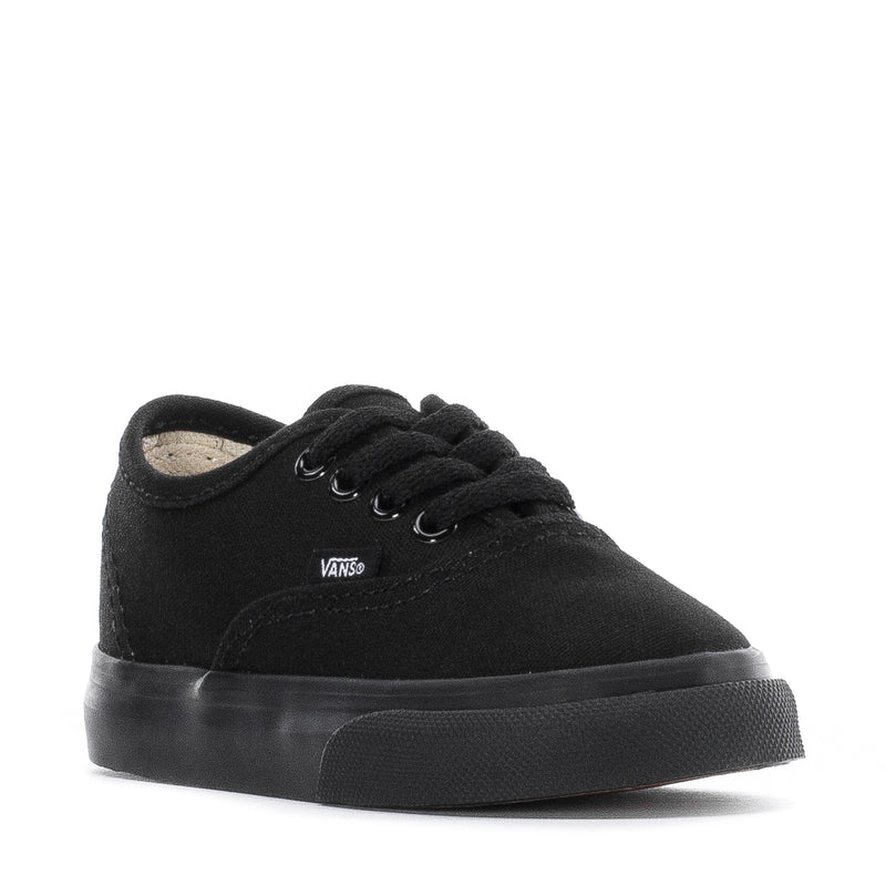 Toddler black low-top sneakers, front view with lace-up eyelets and Vans tag