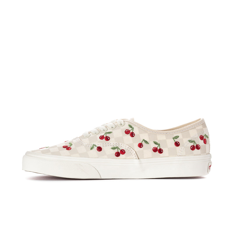 Women’s low-profile sneakers side view with red cherry print on checkerboard canvas