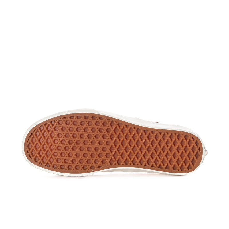 Women’s sneaker outsole view with diamond-texture tread and white rubber edge