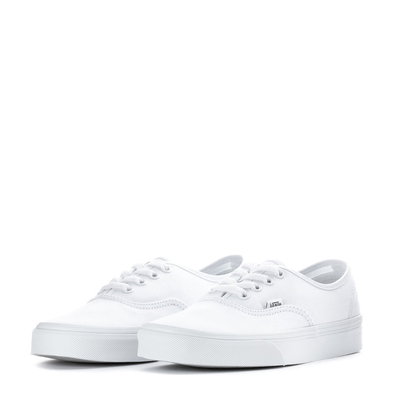 Pair of youth white low-top sneakers with lace-up fronts and rubber toe cap