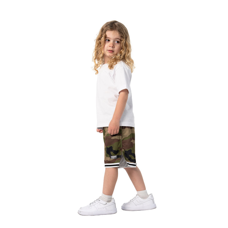 Youth camo basketball shorts on child, side profile with white-and-black trim