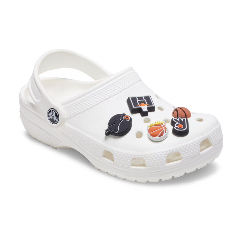 Five basketball-themed Jibbitz charms on white clog