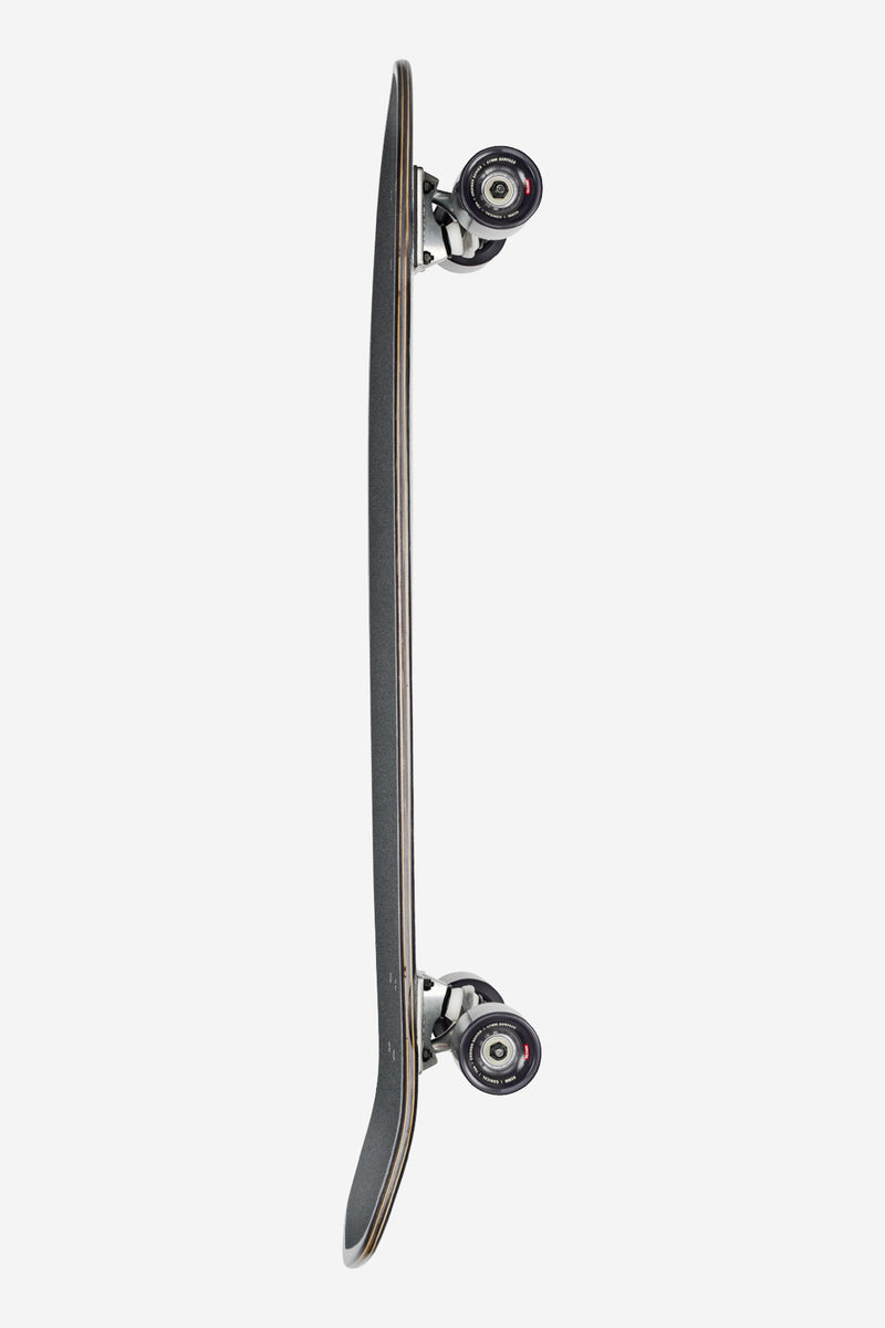 Side profile of Blazer XL Flow longboard showing exposed trucks and black wheels