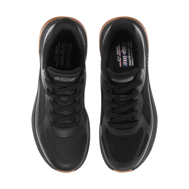 Pair of black slip-on sneakers showing cushioned tongue and laces