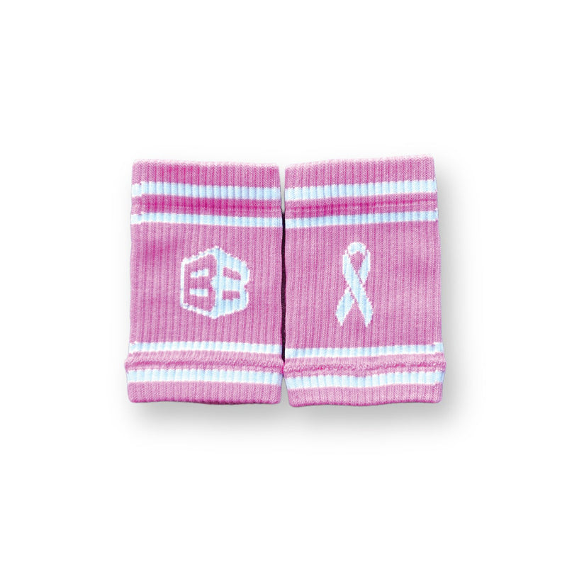 Pink wristbands for crossfit with a logo and breast cancer awareness ribbon on a white background