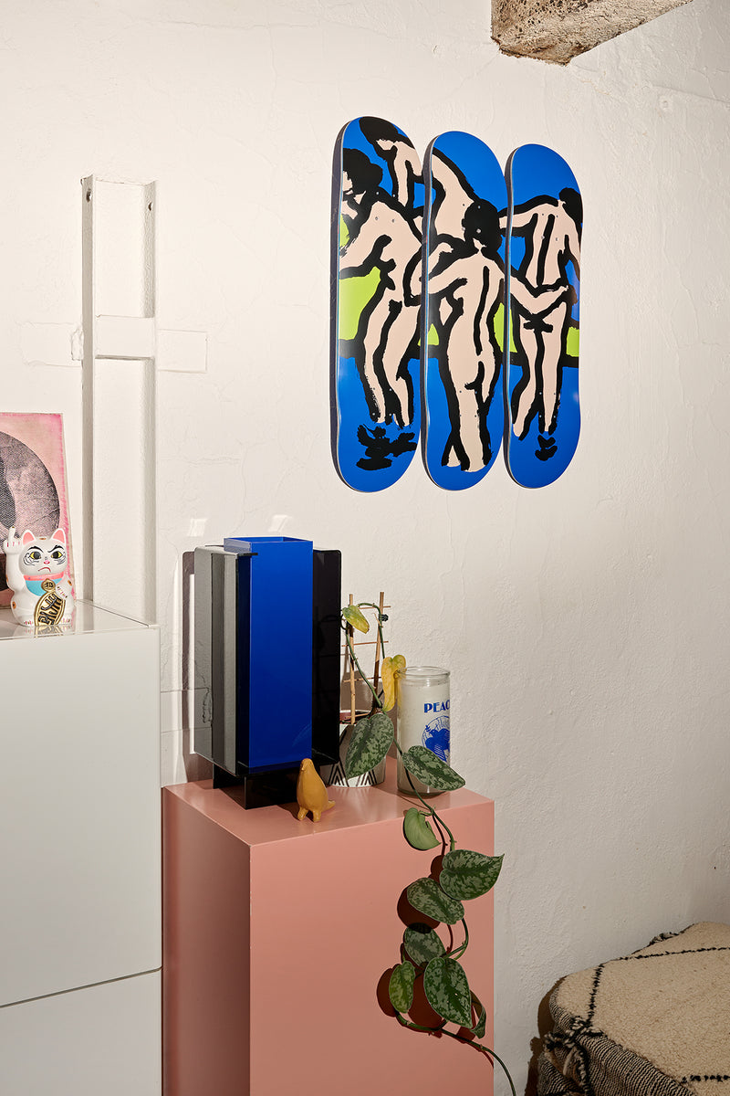 Triptych of three Bathers decks mounted on a wall showing abstract nude figures in blue and beige.