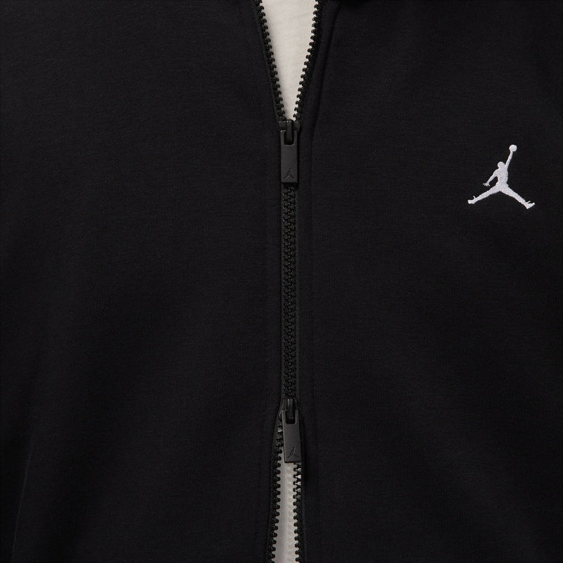 Black zip-up hoodie close-up of front zipper and small Jordan logo on chest.