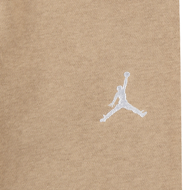 Tan fleece fabric close-up with white Jordan logo