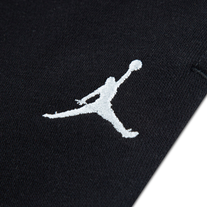 Black youth fleece pants with white Jumpman logo on the leg
