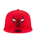 Red baseball cap with embroidered bull logo on the front and curved brim