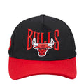 Two-tone snapback hat in black with red Bulls logo and red brim