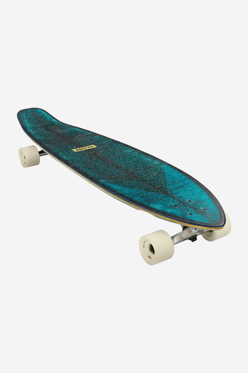 Teal speckled Byron Bay Sun Days longboard with cream wheels viewed from the front-left
