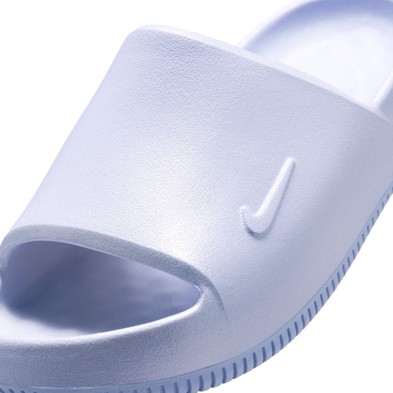 Close-up of youth slide sandal upper in light blue with swoosh-style logo