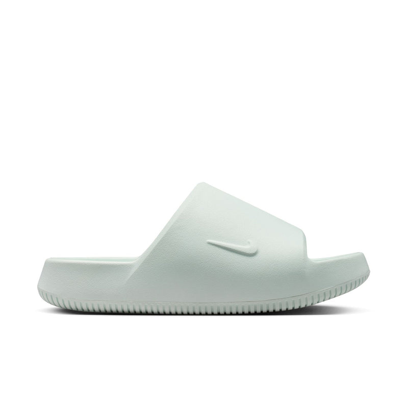 Barely green women's slide sandal with Nike Swoosh on soft upper